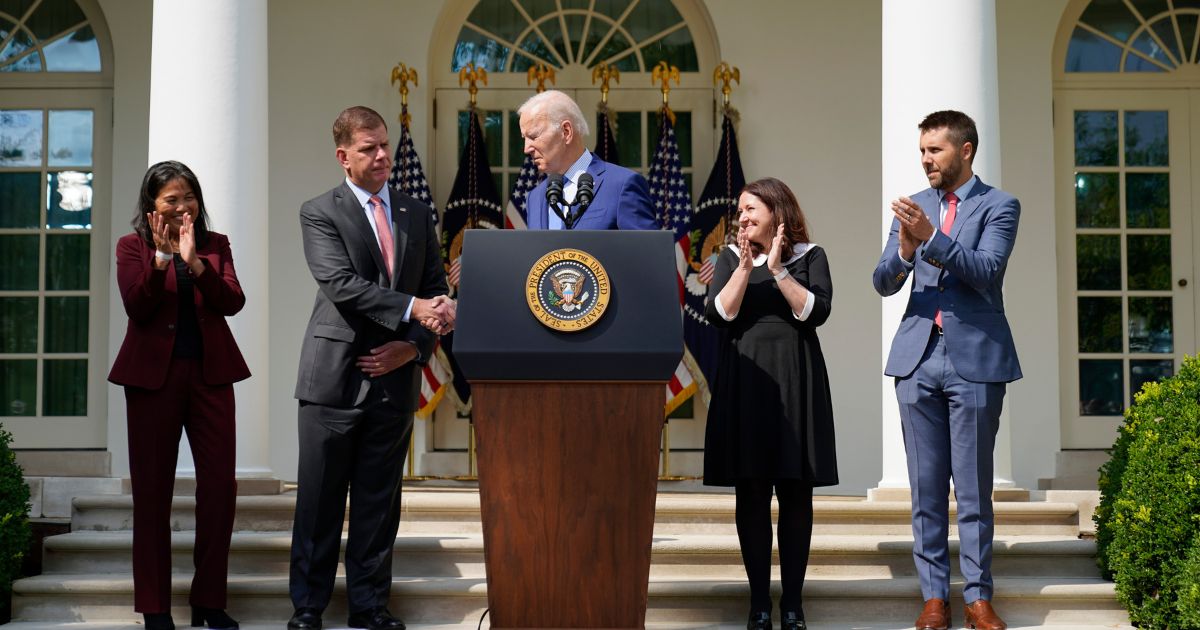 President Joe Biden shakes hands with Secretary of Labor Marty Walsh as he speaks about a tentative railway labor agreement in the Rose Garden of the White House in Washington, D.C., on Sept. 15, 2022. Celeste Drake, second from the right, recently stepped down.