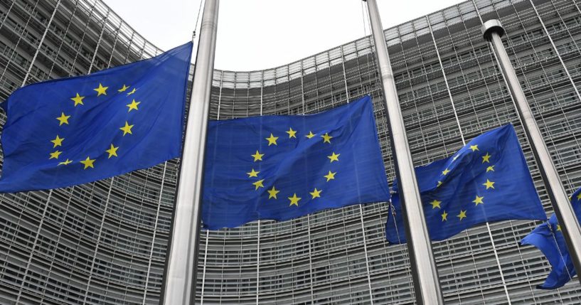 European Union flags fly at half-mast at the EU headquarters in Brussels on Sept. 9, 2022.