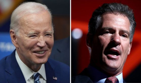 President Joe Biden greets people on Thursday in Salt Lake City. Then-Ambassador Scott Brown speaks on Oct. 12, 2018, in Auckland, New Zealand.