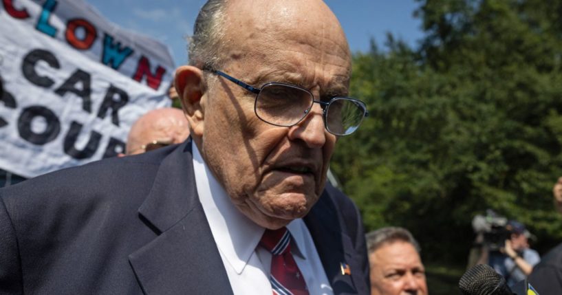 Rudy Giuliani speaks to members of the media after being booked at the Fulton County Jail in Atlanta on Aug. 23.