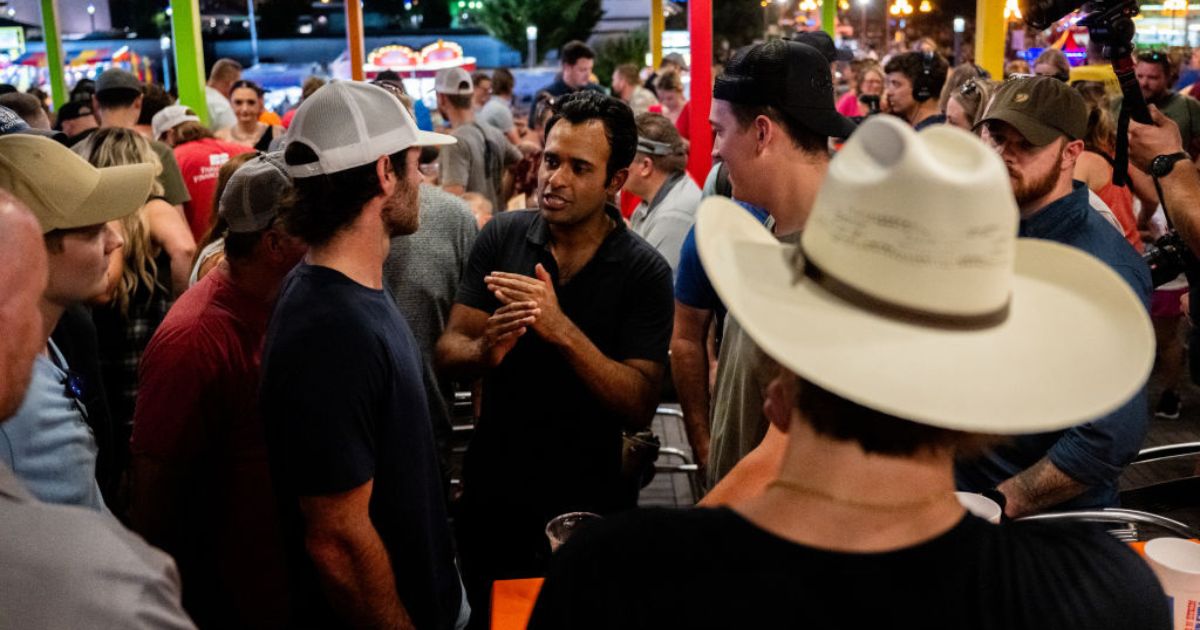 Republican presidential candidate Vivek Ramaswamy, center, speaks with supporters at the Jalapeno Pete's bar at the Iowa State Fair in Des Moines on Friday.