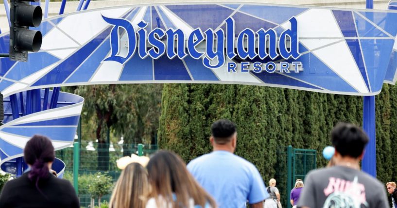 People walk toward an entrance to Disneyland on April 24, in Anaheim, California. Recently, men in dresses were seen greeting young girls wanting to dress up as princesses.