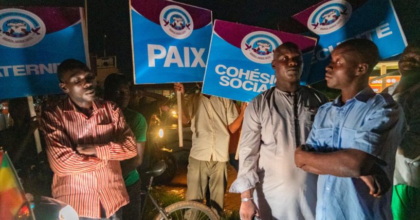 Supporters or Niger's ruling junta, accompanied by some security forces, stand guard at a roundabout in Niamey, Niger, on Sunday.