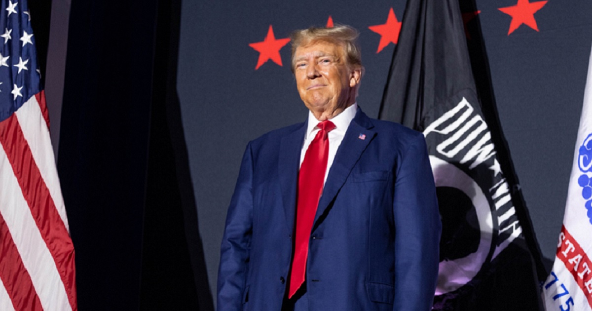 Former President Donald Trump grins at his audience Tuesday before a speech in Windham, New Hampshire.