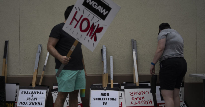 demonstrators picking up signs