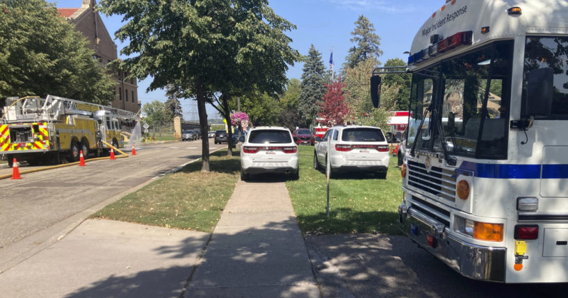 A fleet of emergency vehicles sit parked outside of Minnesota Correctional Facility-Stillwater prison in Bayport, Minn., on Sunday, Sept. 3, 2023. The prison was placed on emergency lockdown after about 100 inmates in a housing unit facing dangerously high heat would not return to their cells.