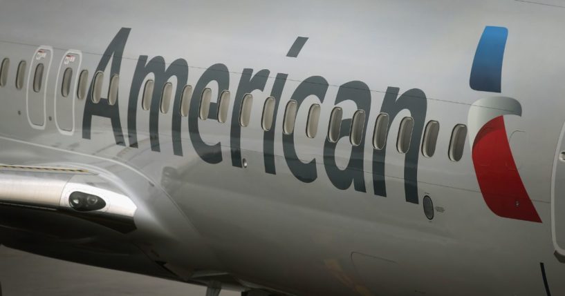 A new American Airlines 737-800 aircraft featuring a new paint job with the company’s new logo sits at a gate at O'Hare Airport in Chicago, Illinois, on Jan. 19, 2013.