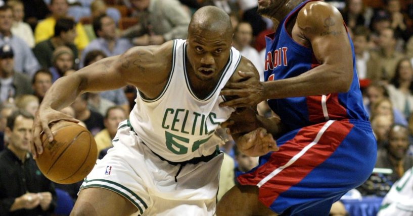 The Boston Celtics' Brandon Hunter, left, drives around the Detriot Pistons' Corliss Williamson in preseason action at Mohegan Sun Arena in Uncallville, Connecticut, on Oct. 8, 2003.