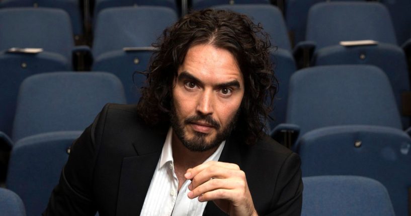 Actor and comedian Russell Brand poses for photographs at the Institute of Education in London on Nov. 25, 2014.