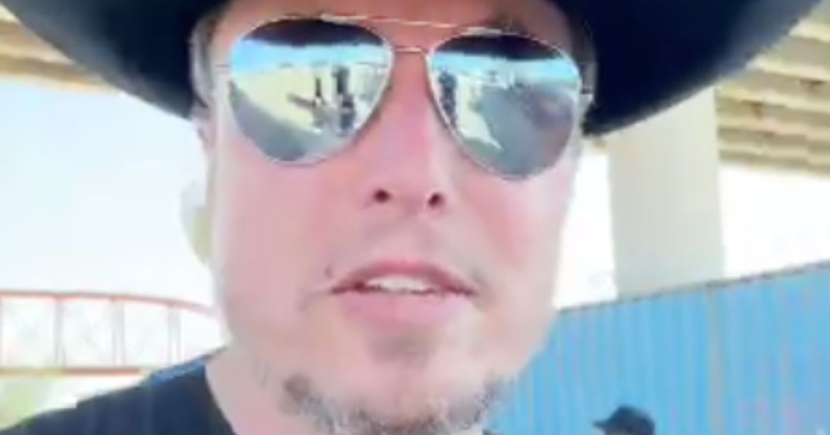Elon Musk in sunglasses and a black cowboy hat at the border