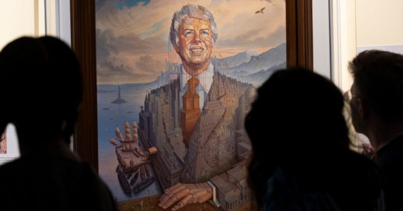 Visitors pass a portrait of President Jimmy Carter during a celebration of his 99th birthday held at The Carter Center in Atlanta on Saturday.