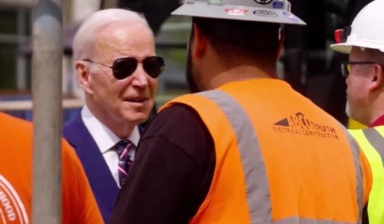 Joe Biden talking to auto workers in a campaign ad