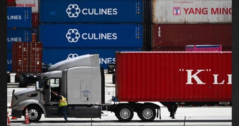 A truck driver prepares to depart with a cargo shipping container from the Port of Los Angeles in Los Angeles, California in this file photo from June 7.