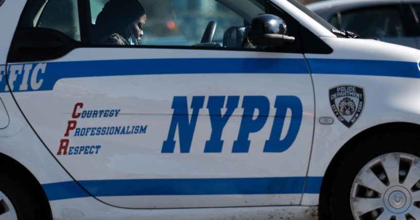 A police officer sits in her car in Harlem where two New York City police officers were shot last night after responding to a domestic call on Jan. 22, 2022, in New York City.