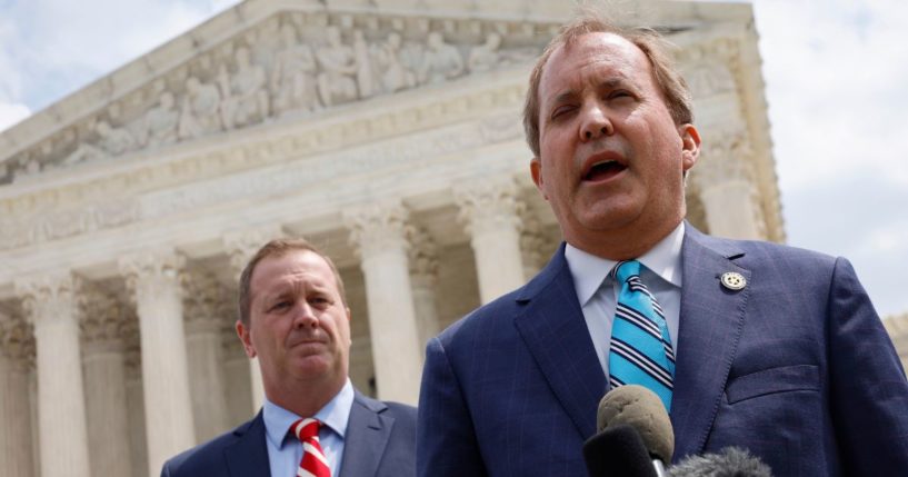 Texas Attorney General Ken Paxton (R) and Missouri Attorney General Eric Schmitt talk to reporters after the U.S. Supreme Court heard arguments in their case about Title 42 on April 26, 2022, in Washington, D.C.