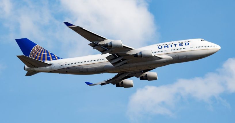 A United Airlines plane flies in this stock image