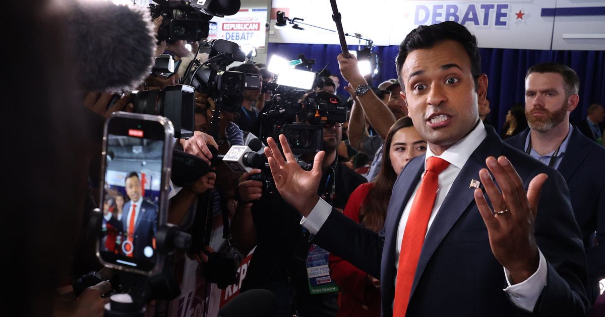 Republican presidential candidate, Vivek Ramaswamy talks to members of the media in the spin room following the first debate of the GOP primary season hosted by FOX News at the Fiserv Forum on August 23, in Milwaukee, Wisconsin. Ramaswamy recently stated that he would make Epstein’s client list public.