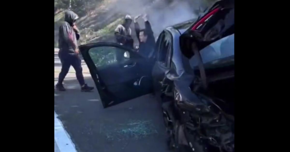 Thieves robbed a driver on a Los Angeles freeway on Tuesday after intentionally crashing into his car.