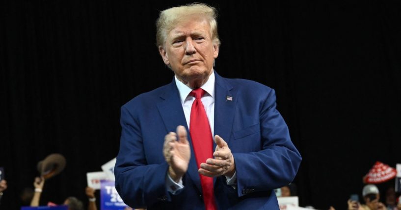 Former president Donald Trump applauds during a Republican rally in Rapid City, South Dakota, Sept. 8.