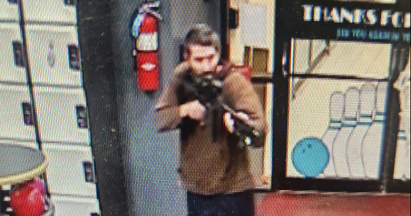 In this image taken from video released by the Androscoggin County Sheriff's Office, an unidentified shooter points a gun while entering Sparetime Recreation in Lewiston, Maine, on Wednesday.