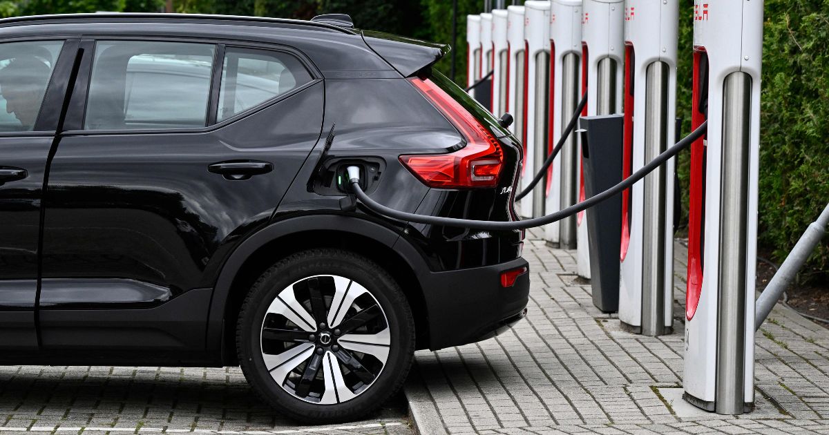 An electric car charges at a charging point reserved for Tesla cars in Breda on September 19, 2023.