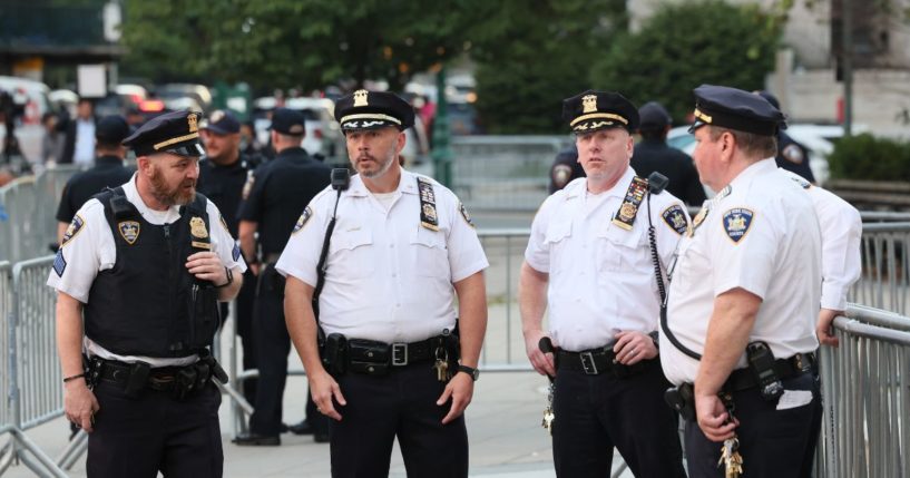 NYPD officers stand guard before the second day of former President Donald Trump civil fraud trial begins at New York State Supreme Court on Tuesday in New York City.