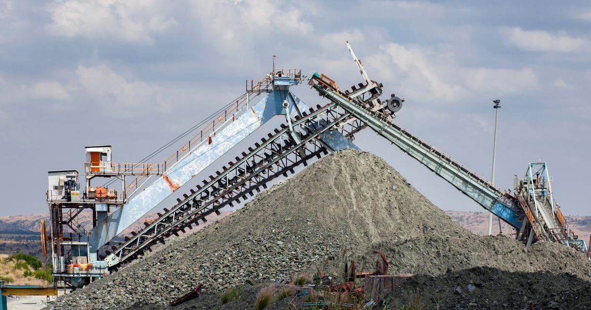 Mining equipment and an escalator over rock dumps at a diamond mine.