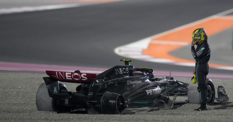 Mercedes driver Lewis Hamilton of Britain stands. next to his car after an Oct. 8 crash