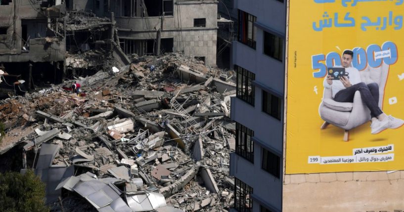 A Palestinian inspects the rubble of a high rise building destroyed by Israeli airstrikes in Gaza City early Sunday.