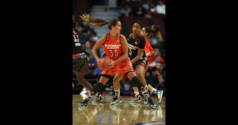 Kathryn Westbeld #33 of the east team looks to pass under pressure from Mikayla Cowling #3 of the west team during the 2014 McDonald's All American Game at United Center on April 2, 2014 in Chicago, Illinois.