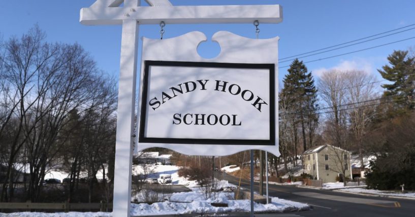 A sign stands near the site of the December 2012 Sandy Hook school shooting on the day of the National School Walkout on March 14, 2018, in Sandy Hook, Connecticut.