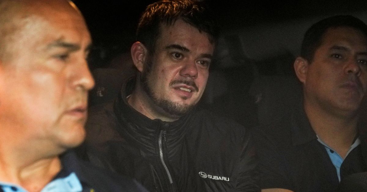 Dutch citizen Joran van der Sloot is driven in a police vehicle from a maximum-security prison to an airport to be extradited to the U.S., on the outskirts of Lima, Peru, on June 8.