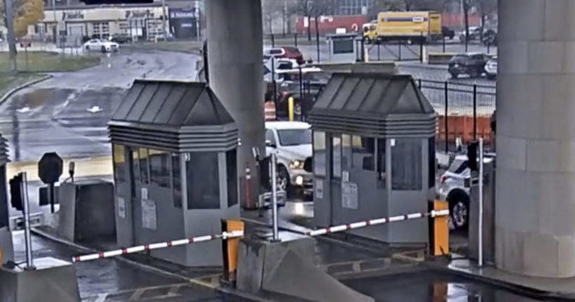 a light colored vehicle traveling toward the Rainbow Bridge customs plaza