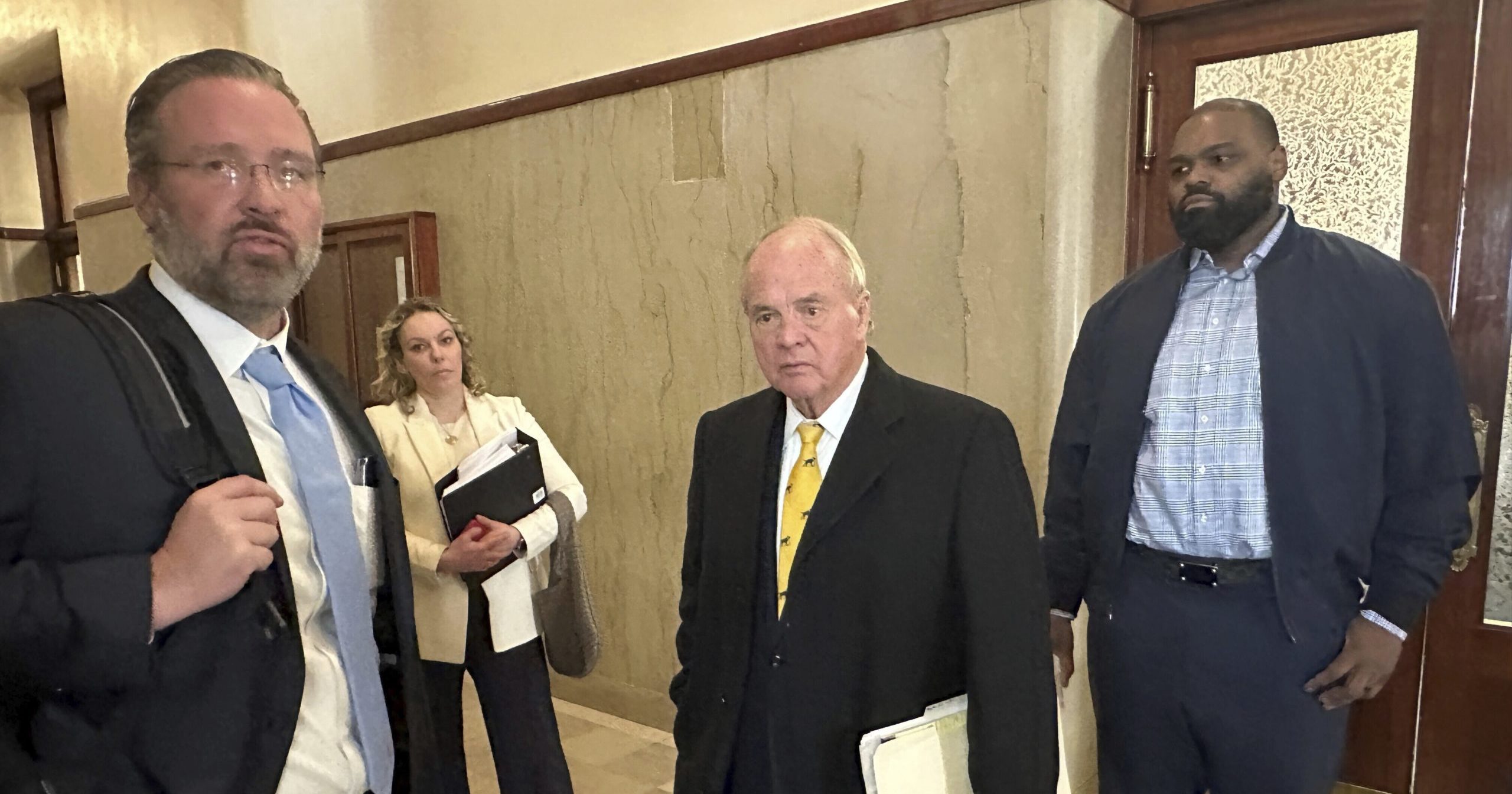 Former NFL football player Michael Oher, right, stands with his lawyers outside a courtroom on Wednesday in Memphis, Tennessee.