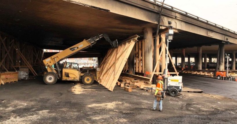 This photo provided by the California Department of Transportation shows a work crew shoring up a section under Interstate 10 that was severely damaged in a fire in an industrial zone near downtown Los Angeles on Wednesday. The area under the freeway was stacked with flammable materials on lots leased by the state through a little-known program that now is under scrutiny.