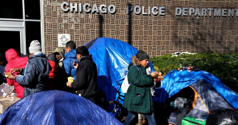 A meal is served to migrants living in a tent community outside a Northside police station in Chicago on Nov. 1.