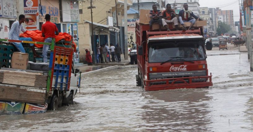 Vehicles try to maneuver through floodwater caused by heavy rain in Mogadishu Saturday. Floods caused by torrential rainfall have killed at least 31 people in various parts of Somalia, authorities said Sunday.