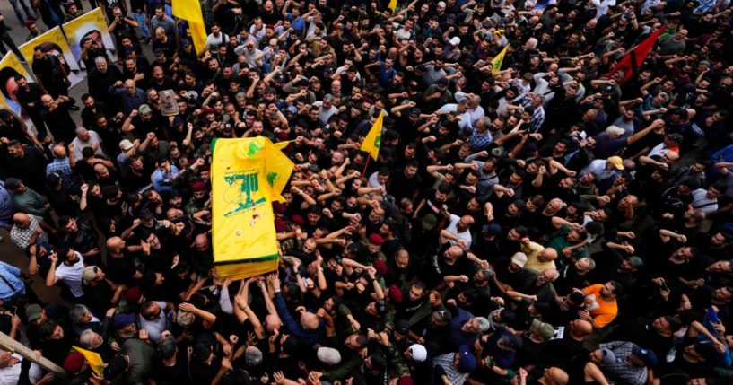 Hezbollah fighters carry the coffin of their comrade, Mohammed Ali Assaf, who was killed by an Israeli strike in Syria Friday, during his funeral procession in the southern Beirut suburb of Dahiyeh, Lebanon, Saturday. Skirmishes between the Iran-backed group and Israeli military continue to intensify along the Lebanon-Israel border, threatening to escalate into another front in the Mideast’s latest war.