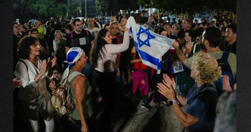 People react as they hear the news of the release of 13 Israeli hostages held by Hamas in the Gaza strip, in Tel Aviv, Israel, on Friday. Friday marked the start of a four-day cease-fire in the Israel-Hamas war, during which the Gaza militants pledged to release 50 hostages in exchange for 150 Palestinians imprisoned by Israel.