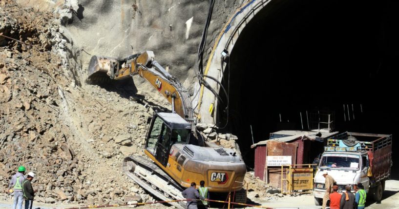 Heavy machinery works at the entrance to the site of an under-construction road tunnel that collapsed in mountainous Uttarakhand state, India. Forty workers were trapped in the collapsed road tunnel for an eighth day Sunday as rescuers waited for a new machine to drill through the rubble so they could crawl to their freedom.