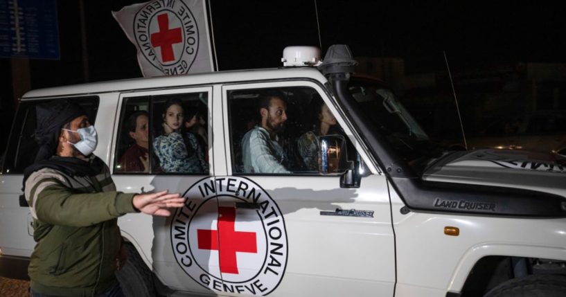 A Red Cross vehicle carrying Israeli hostages drives by at the Gaza Strip crossing into Egypt in Rafah on Saturday.