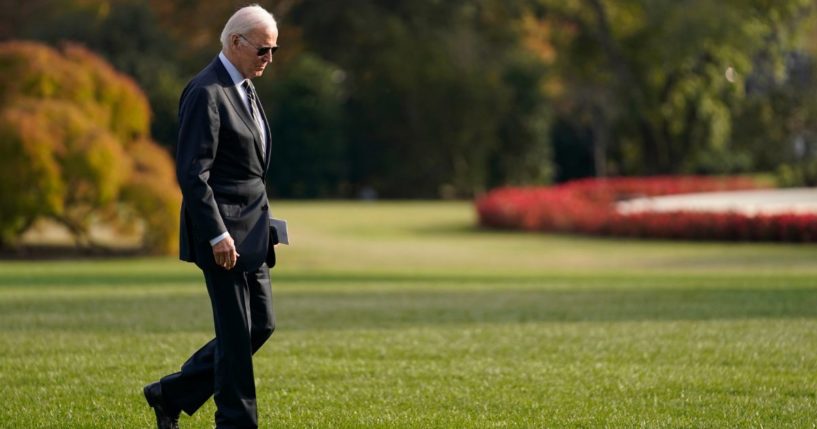 President Joe Biden walking in sunglasses