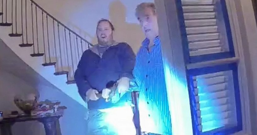 Police footage from Dec. 28, 2022, shows David DePape, left, and Paul Pelosi, right, both holding onto a hammer when greeting officers at the door of the Pelosi home. On Thursday DePape was found guilty on one count of attempted kidnapping and one count of assault.