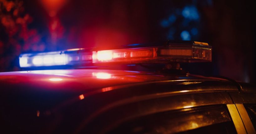 A stock photo shows flashing lights atop a police car.