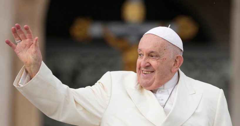 Pope Francis waves to the faithful as he arrives for his weekly general audience in St. Peter's Square at the Vatican Wednesday.