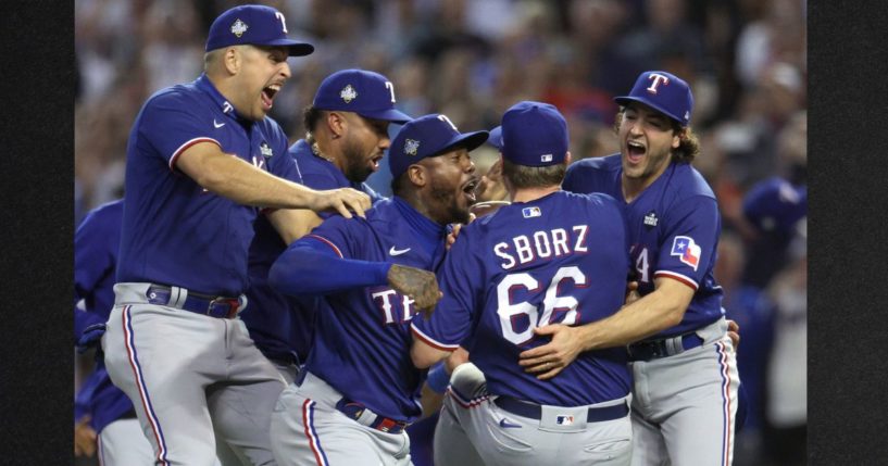 Josh Sborz #66 of the Texas Rangers celebrates with teammates Aroldis Chapman #45, Josh Smith #47 and Nathaniel Lowe #30 after defeating the Arizona Diamondbacks 5-0 in Game Five of the World Series at Chase Field on Nov. 1 in Phoenix, Arizona.