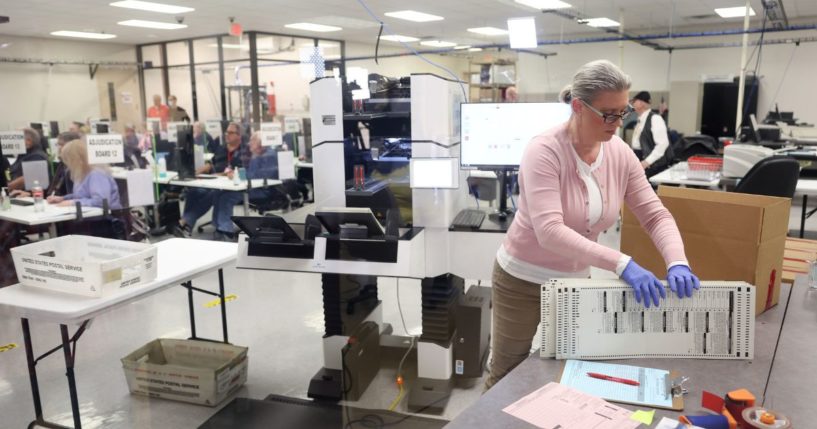 An election worker scans ballots at the Maricopa County Tabulation and Election Center on Nov. 10, 2022, in Phoenix.