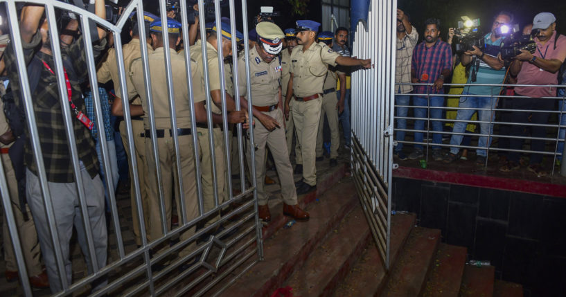 A police officer inspects a spot after a stampede Saturday at the Cochin University of Science and Technology in Kerala state, India. Four people died in the incident.