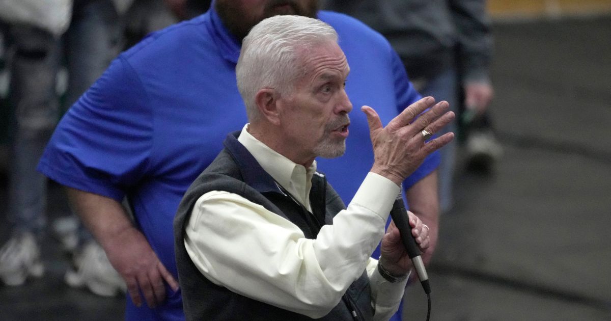 Rep. Bill Johnson answers a question as East Palestine, Ohio Mayor Trent Conaway, rear, listens during a town hall meeting at East Palestine High School in East Palestine, Ohio, on Feb. 15.