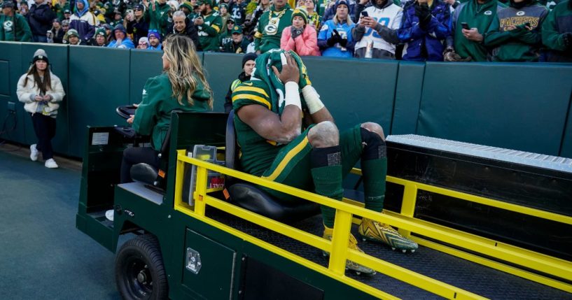 Green Bay Packers running back Aaron Jones is carted off the field during the first half of an NFL football game against the Los Angeles Chargers on Sunday in Green Bay, Wisconsin.